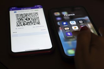 In this photo illustration, the PhonePe QR code, is seen displayed on mobile phones screen in