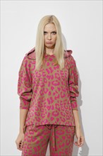 Upset, sad woman in pink pyjama on white background