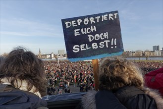 Demonstrators with banner on the topic of remigration, large demonstration against right-wing