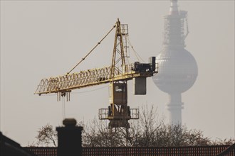 A crane looms in front of the Berlin television tower in Berlin, 29/02/2024