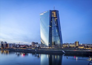 The European Central Bank, ECB, The façade is reflected in the Main River in the evening, Frankfurt