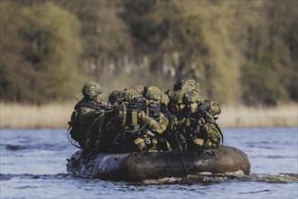 Czech and German soldiers launch an inflatable boat into the Elbe as part of the military exercise