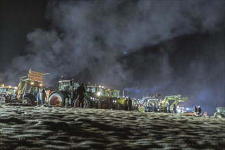 Tractors during a rally as part of the farmers' protests on the snow-covered Kirchbichl,