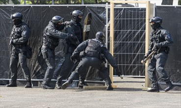 Police officers from the Berlin Special Operations Command, SEK, simulate an attack during an