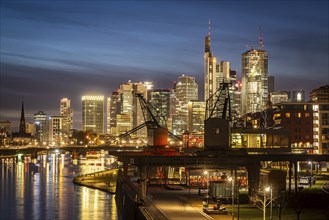 Skyline in the evening, skyscrapers of the banking district, historic harbour cranes at Weseler