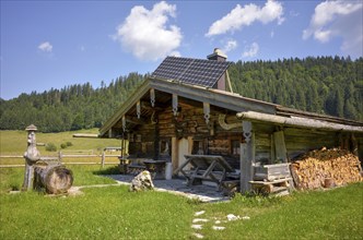 Alpine hut with well and solar panels on the Rötelmoosalm, Chiemgau, Bavaria, Germany, Europe