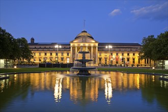 Illuminated spa hotel and Casino in the evening with cascade fountain, Wiesbaden, Hesse, Germany,