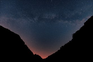 Milky Way in the night sky with mountains in the foreground, Ternitz, Lower Austria, Austria,