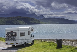 Motorhome parked on the shore along Kyle of Tongue, shallow sea loch in northwest Highland,