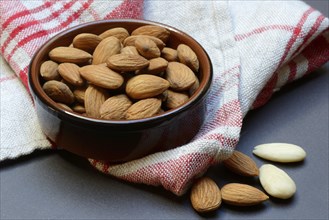 Almonds in small bowls (Prunus dulcis)