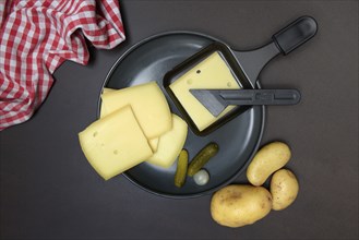 Raclette, cheese slices in raclette pans, Switzerland, Europe