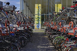 Very many bicycles in the parking spaces of the bike station at the main station,