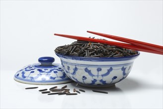 Rice, black wild rice in bowl with chopsticks, Canada, North America