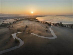 Aerial view of the Radolfzeller Aach at sunrise, which leads through the foggy Radolfzeller