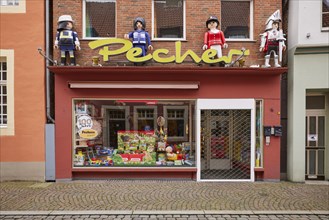 Shop window of a toy shop with oversized Playmobil figures in Warendorf, Warendorf district, North