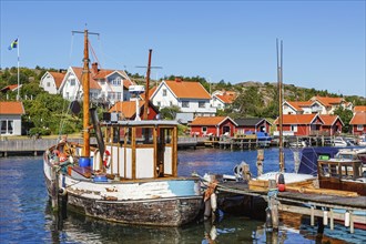 Old fishing boat at a jetty in a fishing village harbour on the Swedish west coast on a sunny