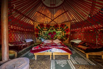 Traditional Kyrgyz yurt for overnight accommodation for tourists, with four beds and carpets, Naryn