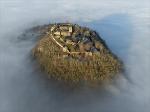 Aerial view of the Hegau volcano Hohentwiel with the upper fortress ruins illuminated by the rising