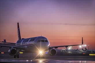 Frost at the airport, a Turkish Airlines aircraft is de-iced in front of sunrise. Airbus A321-231,