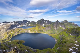 Mountain landscape with steep rocky peaks and lake Tennesvatnet and Krokvatnet, in the back peak of