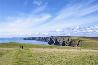 Two tourists hiking to the Duncansby Stacks on the north-eastern tip of Scotland, County Caithness,