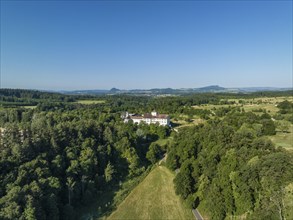 Aerial view of Langenstein Castle near Eigeltingen with surrounding golf course, on the horizon the