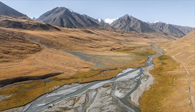 Aerial view, Burkhan mountain valley with meandering river, barren dramatic mountain landscape,