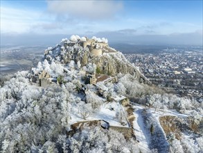 Aerial view of the snow-covered Hegau volcano Hohentwiel with Germany's largest castle ruins,