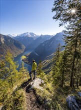 Mountaineers at the Archenkanzel viewpoint, panoramic view of the Königssee, autumn forest and