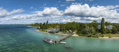 Aerial panorama of the Mettnau peninsula with the landing stage, restaurant and spa centre,