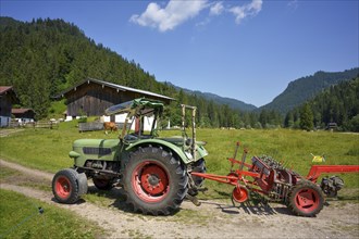 Old Fendt Famer 2 tractor with Pöttinger hay caterpillar at Rötelmoosalm in Bavaria, Germany,