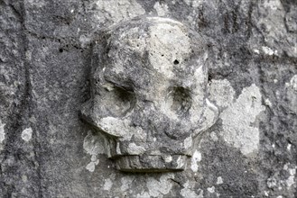 Chiselled skull as decoration on an old weathered gravestone, Kilmartin, Argyll and Bute, Scotland,