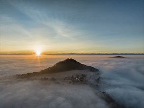 Aerial view of the wintry and fog-covered Hegaulandschaft at sunrise, the volcanic cones Hohenhewen