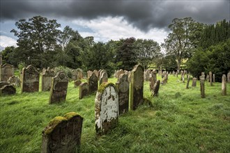 Weathered gravestones in the old graveyard of the monastic ruins of Lanercost Priory, County