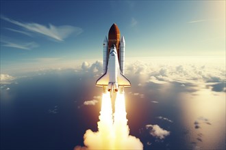 Aerial view of a rocket shuttle carrier launch at sunrise over an ocean coast. The rocket is