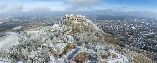 Aerial panorama of the snow-covered Hegau volcano Hohentwiel with Germany's largest castle ruins,