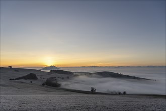 View from the old post road near Leipferdingen into the wintry and misty Hegaulandschaft shortly in