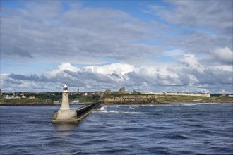 Tynemouth Lighthouse with the ruins of Tynemouth Priory and Castle behind, North Shields, Newcastle