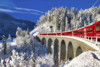 Rhaetian railway on viaduct in winter landscape, near Filisur, Canton Graubünden, Switzerland,