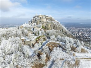 Aerial view of the snow-covered Hegau volcano Hohentwiel with Germany's largest castle ruins,