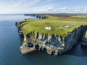 Aerial view of the rugged coastal landscape at Duncansby Head with the lighthouse and the Duncansby