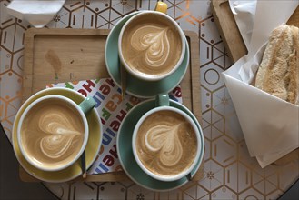 Three cappuccinos with heart in milk foam, Genoa, Italy, Europe