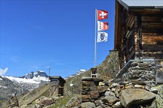 Flagpole with the flags of Switzerland, the canton of Valais and the Academic Alpine Club of Bern