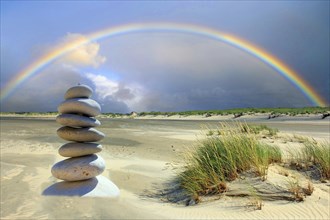 Pebble tower on the beach of the island of Borkum, rainbow, island of Borkum, Lower Saxony, Federal