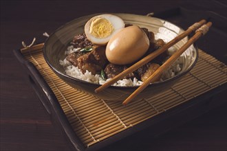 Stewed eggs, with pork belly, and rice, chinese food, homemade, selective focus, rustic, no people