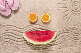 Summer wallpaper, drawing on sand, sea waves and sun, face shape of summer fruits, pink flip-flops,