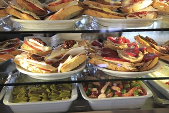 Tapas food display inside famous historic Los Gatos Cervecerias bar, Madrid city centre, Spain,