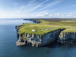 Aerial view of the rugged coastal landscape at Duncansby Head with the lighthouse and the Duncansby