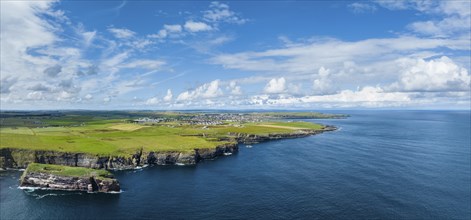 Aerial panorama of rugged cliffs on the North Sea coast, with the harbour town of Wick on the