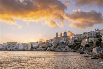 View of the village with the Greek Orthodox church of Agios Nikolaos, Asteria Beach, at sunset with